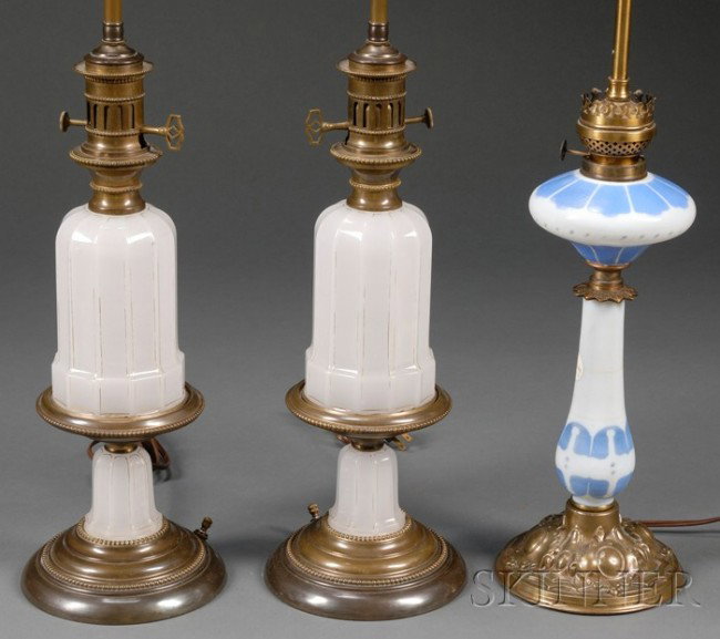 Three Opaline Glass Oil Lamp Bases, late 19th cent: Three Opaline Glass Oil Lamp Bases, late 19th century, comprising one with light blue painted ogee flute accents, on brass foot, ht. to top of font 16, and a pair with paneled cylindrical bodies and s