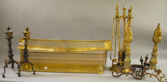 Group of Brass Fireplace Andirons and Tools, two p: Group of Brass Fireplace Andirons and Tools, two pairs of andirons, two fireplace fenders, a stand with shovel, a stand with a set of three tools, and a pair of fireplace tools.