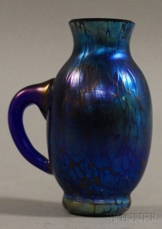 Loetz Miniature Iridescent Blue Art Glass Jug, pa: Loetz Miniature Iridescent Blue Art Glass Jug, paper label "Czech-Slovakia," ht. 2 in.