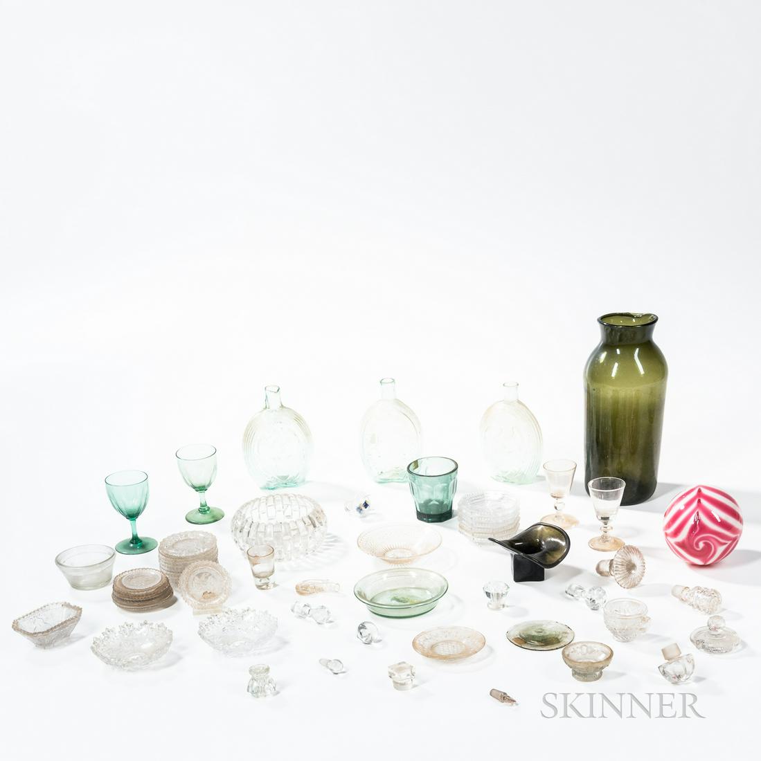 Group of Free-blown and Blown-molded Glass Objects,: Group of Free-blown and Blown-molded Glass Objects, mostly 19th century, including cup plates, aqua flasks, a large olive green jar, a red and white swirled ball, stoppers, four stemmed wines, a tumbl