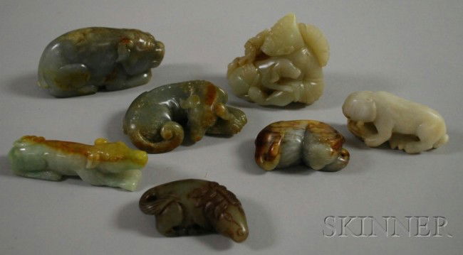 Seven Chinese Jade Carved Pendants and Figures, in: Seven Chinese Jade Carved Pendants and Figures, including a white seated figure with dog, ht. 2 3/4; a gray and brown seated pig, lg. 3; a white pendant with lion and turtles, lg. 3; a dark green dog,