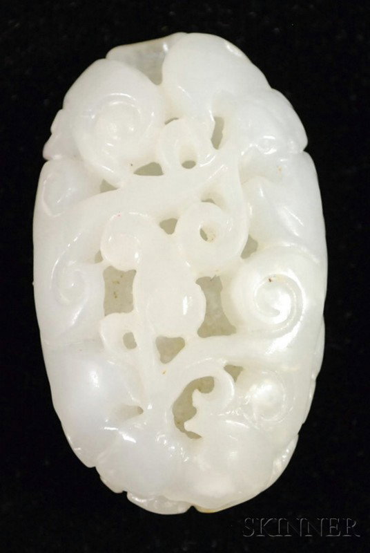 Suzhou Jade Carving, China, of pebble shape, carv: Suzhou Jade Carving, China, of pebble shape, carved in openwork with bats and ruyi scrolls, the reverse as a large lotus leaf, white color, lg. 1 3/4 in.
