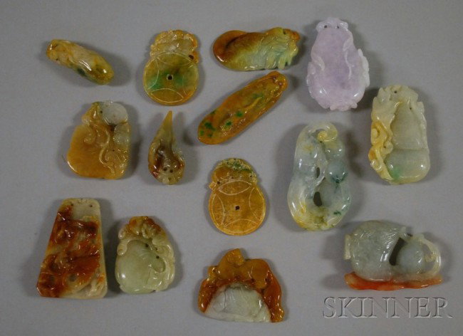 Fourteen Carved Chinese Jade Pendants, a purple ve: Fourteen Carved Chinese Jade Pendants, a purple vegetable and bats pendant, ht. 2 1/2; a white and green mythical beast pendant, lg. 2 1/2 in.; two primarily brown disk and mythical beast pendants; a 