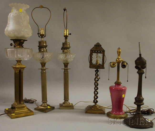 Six Assorted Table Lamp Bases, a pair of silver-p: Six Assorted Table Lamp Bases, a pair of silver-plated columnar kerosene, a single brass-plated columnar kerosene, a brass barley-twist lantern-form, a cast metal, and a glazed ceramic, (electrified).