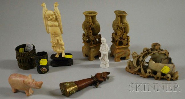 Nine Asian and Ethnographic Decorative Objects, t: Nine Asian and Ethnographic Decorative Objects, three carved soapstone vases, ht. to 5 in.; a porcelain blanc-de-chine female figure; a standing bone figure on stand; a metal cased figure of a hand; a