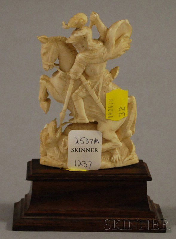 Ivory Carving of St. George and the Dragon, late: Ivory Carving of St. George and the Dragon, late 19th century, on wooden stand, (plume re-glued, upper lance is broken), figure ht. 4 1/4 in.