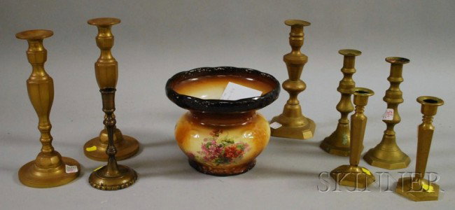 Eight Brass Candlesticks and a Warwick Ioga Ceram: Eight Brass Candlesticks and a Warwick Ioga Ceramic Spittoon, including three candlestick pairs.