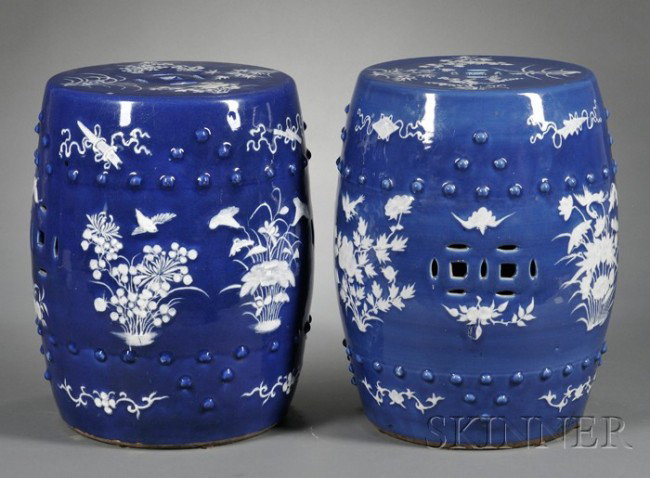 Near Pair of Chinese Export Porcelain Garden Seats,: Near Pair of Chinese Export Porcelain Garden Seats, late 19th century, barrel-form seats with pierced cashes and borders of bosses in relief, blue glaze ornamented with white flowers, birds, butterfli
