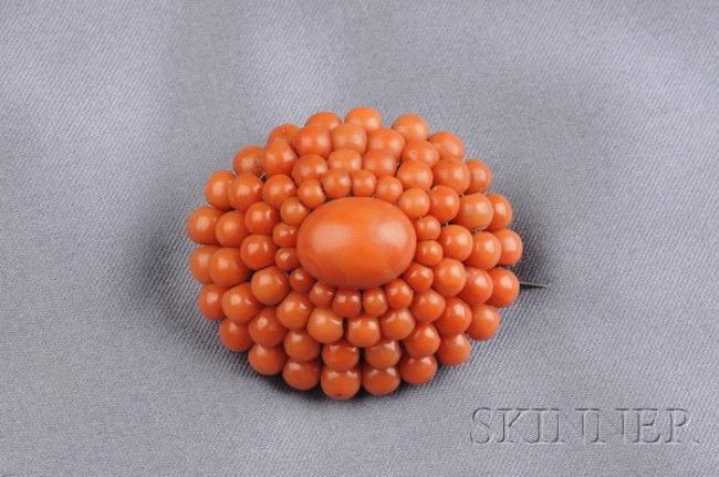 Antique Coral Brooch, set with an oval cabochon co: Antique Coral Brooch, set with an oval cabochon coral, framed by four rows of coral beads, silver mount, lg. 1 1/2 in.