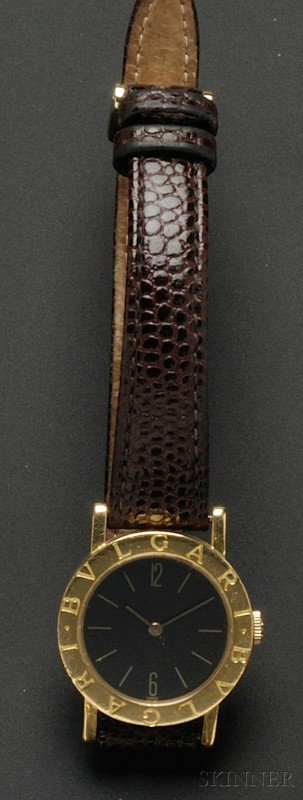 18kt Gold "Bulgari Bulgari" Wristwatch, the black : 18kt Gold "Bulgari Bulgari" Wristwatch, the black metal dial with Arabic and baton numeral indicators, enclosing a quartz movement, completed by a brown lizard strap.