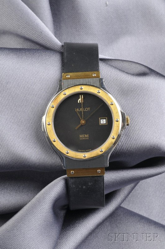 Lady's Stainless Steel "MDM" Wristwatch, Hublot, t: Lady's Stainless Steel "MDM" Wristwatch, Hublot, the black dial with date aperture, enclosing a quartz movement, gold-tone bezel and accents, completed by a black rubber strap with folding clasp, inte