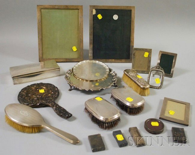 Group of Silver Dresser and Table Articles, compris: Group of Silver Dresser and Table Articles, comprising hand mirror, four brushes, two small waiters, cigarette box, and six picture frames; sold with a paste-set frame and four plain Dunhill lighters.