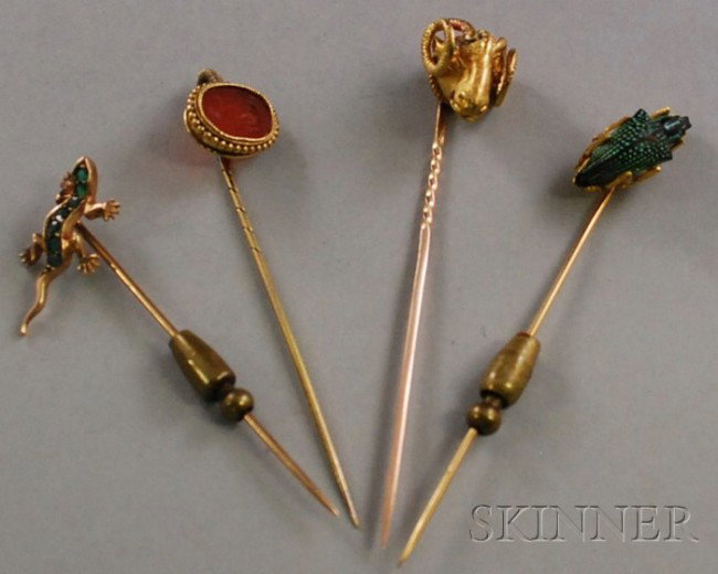 Four Antique Stickpins, including a 14kt gold gem-: Four Antique Stickpins, including a 14kt gold gem-set lizard, a carnelian intaglio, and a glass beetle.