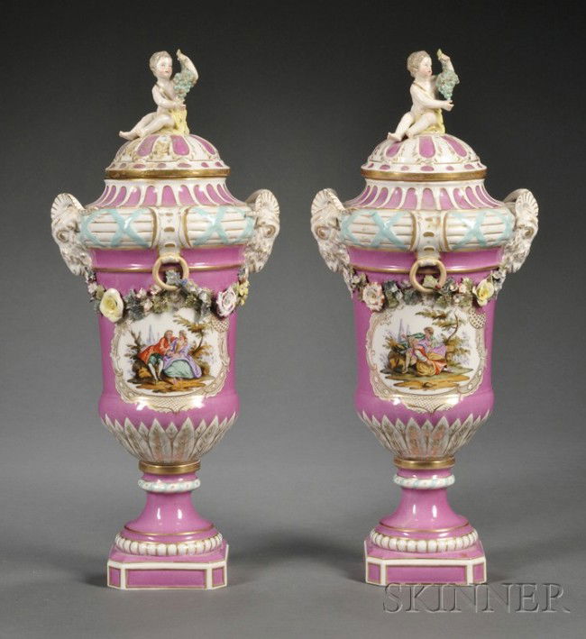 Pair of KPM Porcelain Pink Ground Vases and Covers: Pair of KPM Porcelain Pink Ground Vases and Covers, Germany, late 19th century, finial of cherubs holding bunches of grapes, ram's head handles, applied floral festoons above polychrome enameled carto