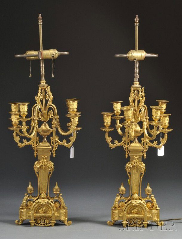 Pair of Bronze Dore Six-light Candelabra, France, : Pair of Bronze Dore Six-light Candelabra, France, 19th century, each with scrolled foliate-decorated arms with torches supported atop architectural columns mounted on scrolled foliate-decorated feet, 