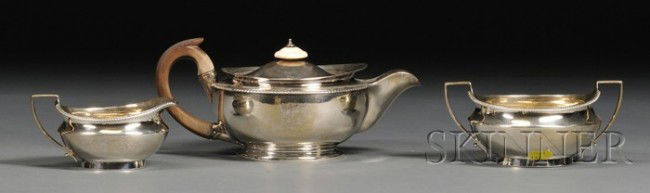 Three-piece George III Silver Tea Set, London, 180: Three-piece George III Silver Tea Set, London, 1803-04, Hannah Northcote, maker, ovoid, with beaded upper rim, short spouts, and angular handles, comprising a teapot with ivory lid finial and fruitwoo