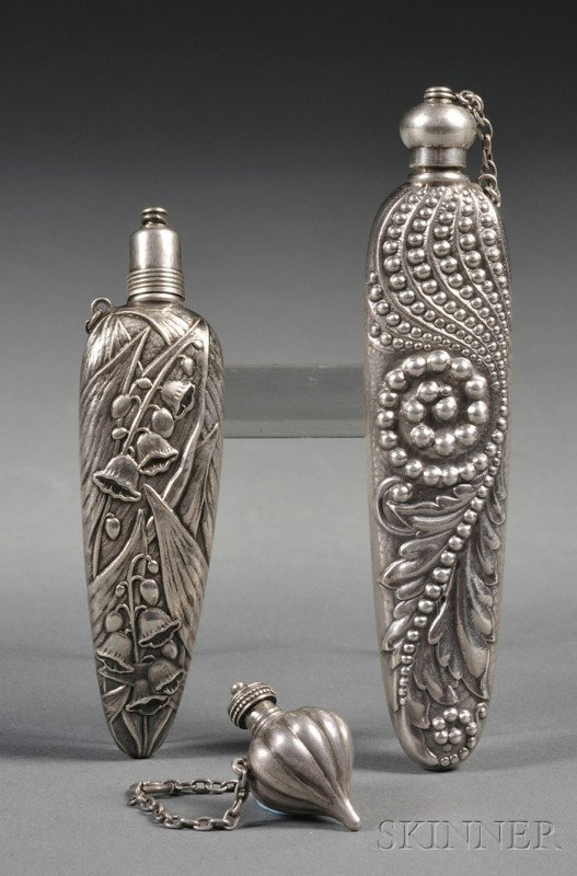 Three Small Sterling Scent Vials, late 19th centur: Three Small Sterling Scent Vials, late 19th century, two Gorham, a curved ovoid form with lilies of the valley, lg. 3 3/8, and a miniature reeded ovoid form for use on a chatelaine, lg. 1 1/4, the thi