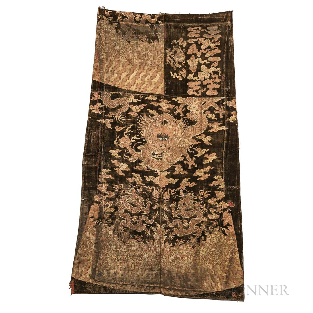 Fragment of a Velvet Brocade Robe, China, possibly 17th/18th century, a central front-facing: Fragment of a Velvet Brocade Robe, China, possibly 17th/18th century, a central front-facing four-clawed mang dragon clutching a flaming pearl, two side-facing dragons below, above a border of rolling