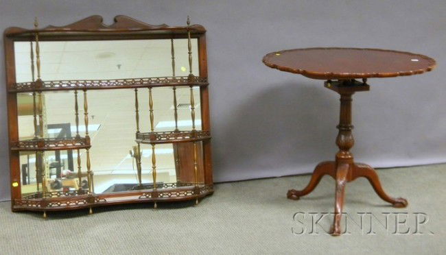 Chippendale-style Mahogany and Brass Mirrored Wal: Chippendale-style Mahogany and Brass Mirrored Wall Shelf and Carved Pie Crust-top Birdcage Tea Table, the shelf branded "F. & G Furniture, Adolfo Genovese, Cambridge, Mass.," lg. 35 1/2, wd. 37 1/2, d