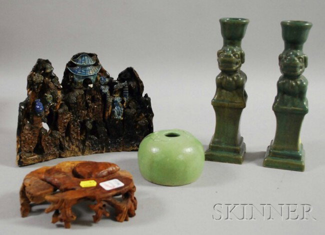 Five Assorted Asian Items, a pair of celadon glaz: Five Assorted Asian Items, a pair of celadon glazed figural candlesticks, a celadon glazed water pot with relief bat motifs on the shoulder, a glazed pottery group of a jungle village, and a carved ro