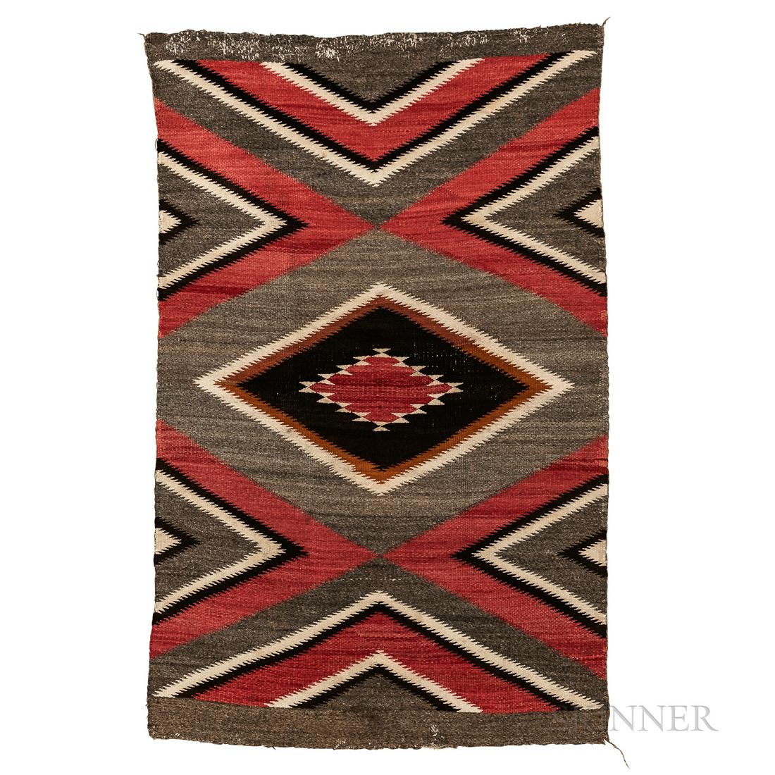 Navajo Rug, the central multicolored diamond device, surrounded by chevrons, on a dark gray ground, (1 of 1)