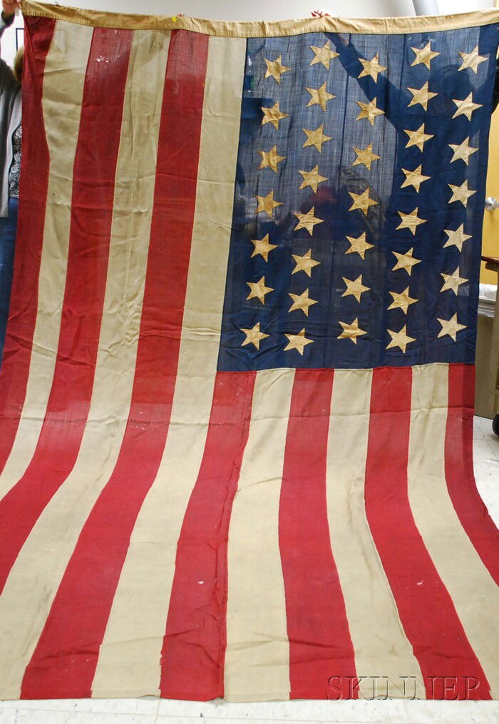 1867-1877 Thirty-seven Star American Flag, linen p: 1867-1877 Thirty-seven Star American Flag, linen pieced-construction and applique stars with hand-stitching, (holes, repairs), approx. 80 x 137 in.