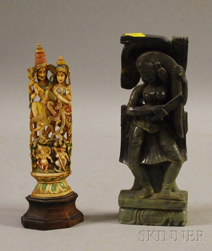 Two Indian Carvings, a soapstone carving of a woma: Two Indian Carvings, a soapstone carving of a woman combing her hair and a polychrome-painted ivory carving of deities, on a wood base, ht. to 8 in.