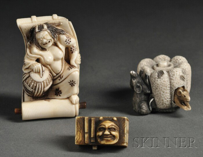 Three Ivory Netsuke, Japan, carved as a man lying : Three Ivory Netsuke, Japan, carved as a man lying on an open scroll and holding a large bell, signed "Enobu"; two mice in and on a melon, signed "Yoshitsugu"; and a small rectangular box with a mask o