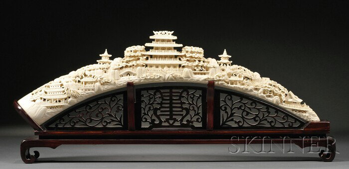 Large Ivory Tusk, Japan, elaborately carved and pi: Large Ivory Tusk, Japan, elaborately carved and pierced with a panorama of landscape and city life with pavilions, trees, mountains, and figures in various attitudes, two-part wood stand, lg. 31 1/4 i