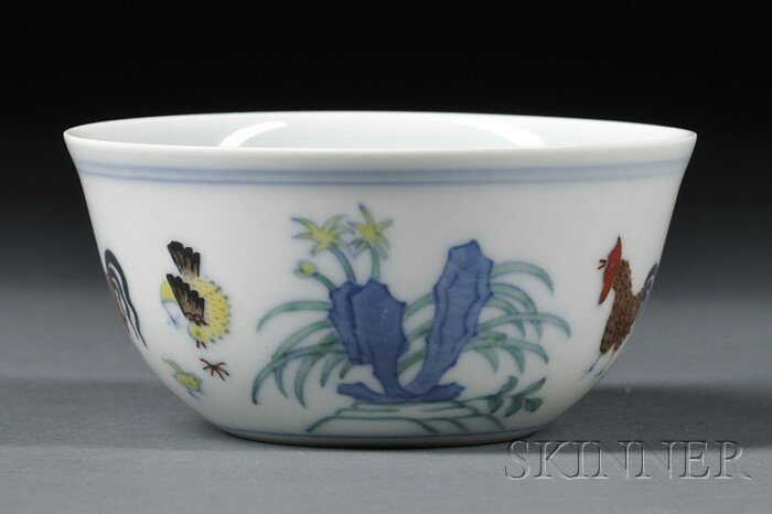 Doucai Chicken Cup, China, Chenghua-style, the ext: Doucai Chicken Cup, China, Chenghua-style, the exterior finely painted with a chicken group amidst iris and peony branches issuing from rockery, under double bow strings around the rim, Chenghua mark 