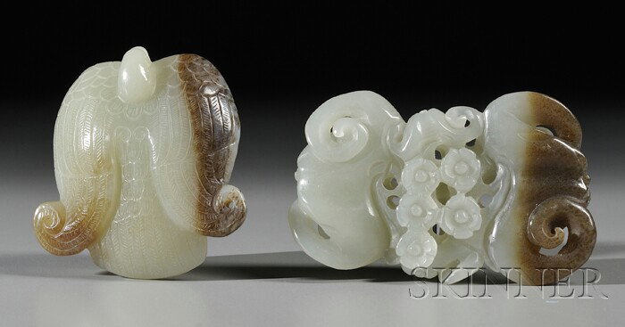 Two Jade Pendants, China, one carved in the shape : Two Jade Pendants, China, one carved in the shape of a mythical bird, the other as two bats embracing prunus blossoms, the stones of gray-celadon color with russet markings, lg. 2 1/4, 2 3/4 in.