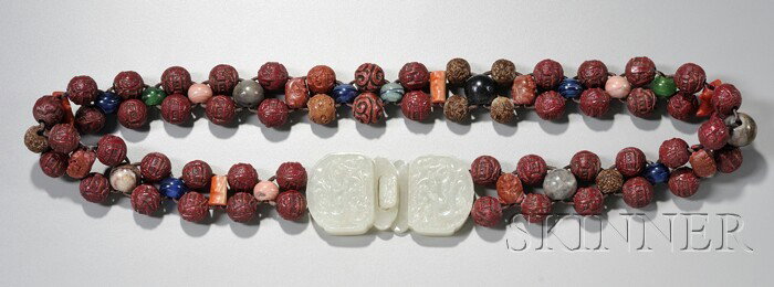 Cinnabar Beaded Belt and Jade Buckle, China, 19th: Cinnabar Beaded Belt and Jade Buckle, China, 19th century, the belt consisting of carved cinnabar beads interspersed with coral, soapstone, and glass beads, the gray-white jade buckles carved with chi