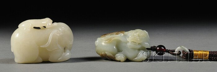Two Jade Carvings, China, a celadon jade carved : Two Jade Carvings, China, a celadon jade carved as a recumbent bixie holding a lingzhi sprig in its mouth, and a white jade carving of a monkey riding an elephant, lg. 2 1/4, 2 3/8 in.