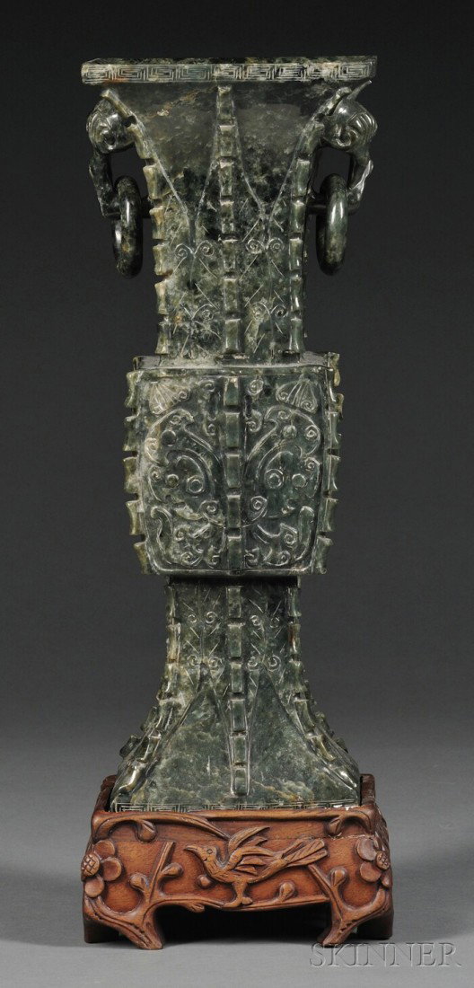 Large Jade Fang Zun, China, with square midsecti: Large Jade Fang Zun, China, with square midsection, slightly splayed foot, and flaring neck, the sides carved with taotie masks separated by notched flanges, flanked by double lingzhi lugs suspending 