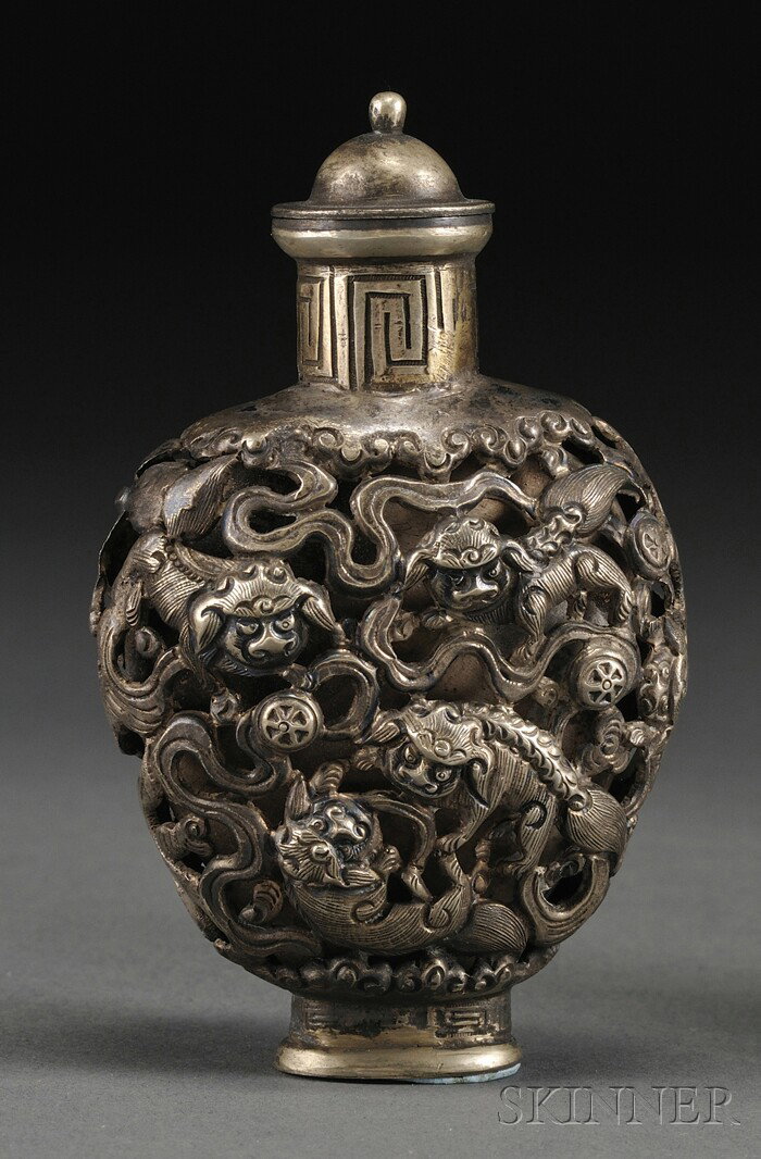 Silver Snuff Bottle, China, 19th century, the rou: Silver Snuff Bottle, China, 19th century, the rounded heart-shaped body with reticulated silver design of foo dogs in various attitudes playing with brocade balls, domed stopper, lg. 2 5/8 in.