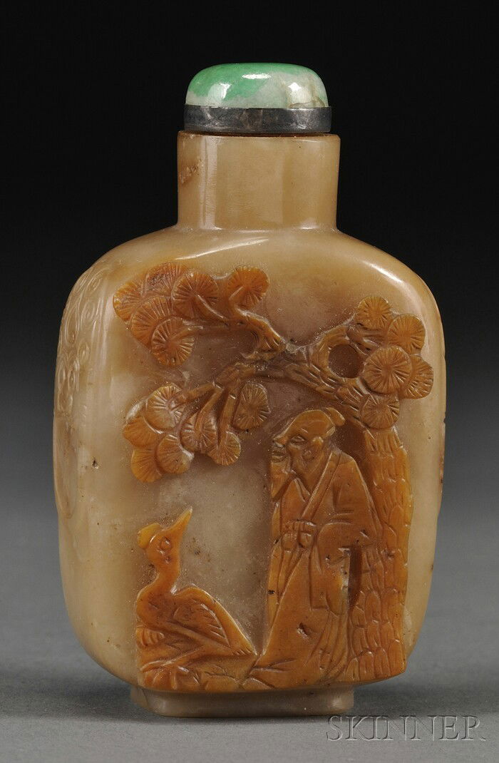 Jade Snuff Bottle, China, late 19th century, of f: Jade Snuff Bottle, China, late 19th century, of flattened oblong shape, carved in relief with an Immortal and a crane under a pine tree, flanked by foo dog lugs, the stone of ochre color, jadeite stop