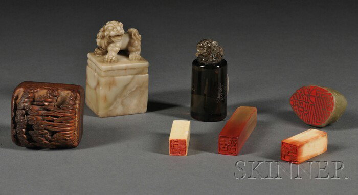 Seven Seals, China, one soapstone with a finial i: Seven Seals, China, one soapstone with a finial in the shape of a foo dog, with inscription (dated the second month of wushen year), a smoky quartz with a toad finial, a wood with rows of bamboo shoot