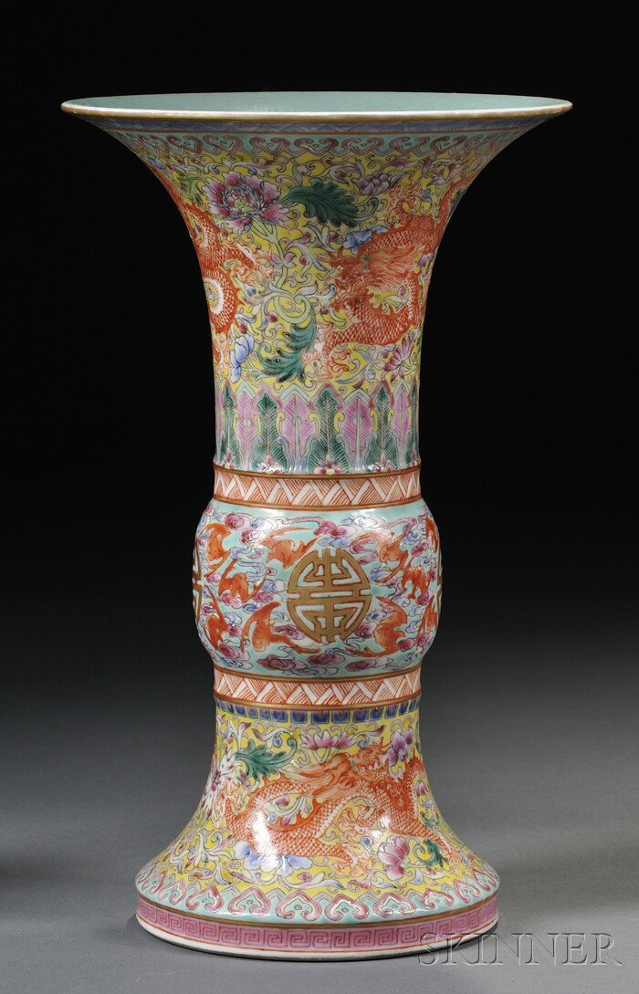 Porcelain Gu Vase, China, the beaker vase painted: Porcelain Gu Vase, China, the beaker vase painted in polychrome enamels with dragons striding amidst flower scrolls, the mid-section decorated with shou roundels amongst bats, Jiaqing mark to the base