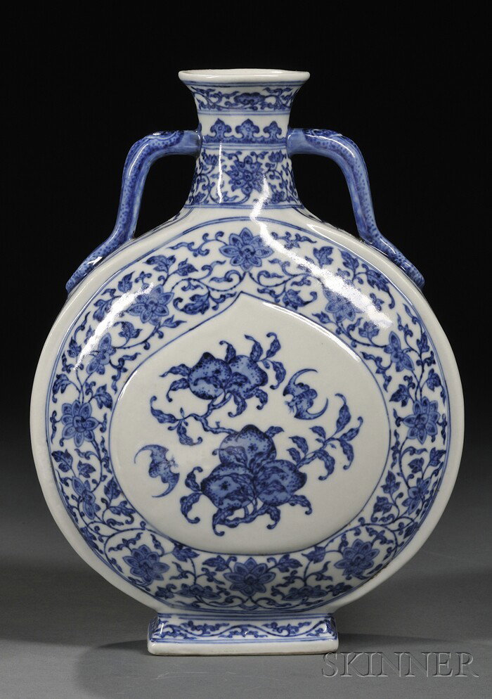 Blue and White Moon Flask, China, each side paint: Blue and White Moon Flask, China, each side painted in underglaze blue with a peach-shaped panel enclosing bats flying atop peach branches, reserved on a lotus stroll ground, ruyi handles resting on b