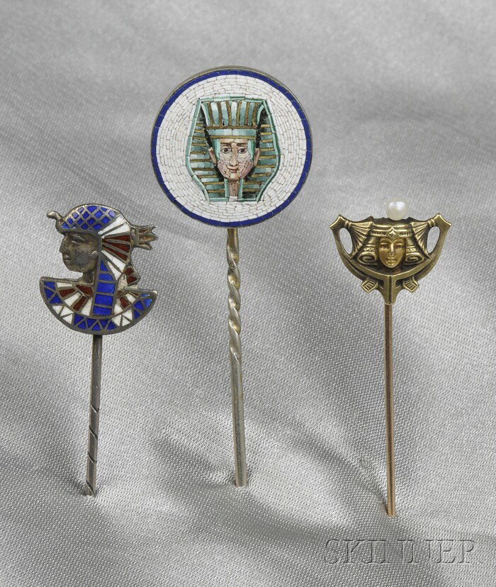 Three Egyptian Revival Stickpins, a micromosaic ph: Three Egyptian Revival Stickpins, a micromosaic pharaoh, silver-gilt mount, another in .800 silver and enamel, the third 14kt gold with seed pearl accent.