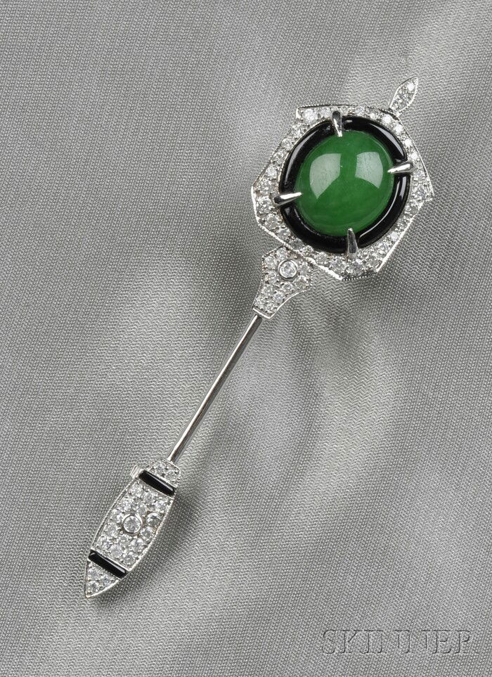 18kt White Gold, Jadeite, Onyx, and Diamond Brooch: 18kt White Gold, Jadeite, Onyx, and Diamond Brooch, set with an oval double cabochon jadeite measuring approx. 12.35 x 10.70 x 4.05 mm, framed by shaped black onyx segments, further pave-set with full