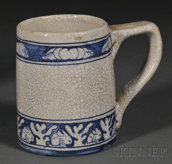 Dedham Pottery Handled Mug Glazed earthenware Dedha: Dedham Pottery Handled Mug Glazed earthenware Dedham, Massachusetts, 1896-1929 Rabbit decorated blue border with white crackle glaze, blue stamp mark, ht. 4 3/4 in.
