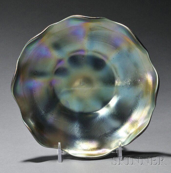 Tiffany Blue Favrile Glass Dish Iridescent glass N: Tiffany Blue Favrile Glass Dish Iridescent glass New York, early 20th century Undulating rim on shallow round dish with eight ribs, inscribed L.C.T. on base with polished pontil, ht. 1 3/8, dia. 6 1/8