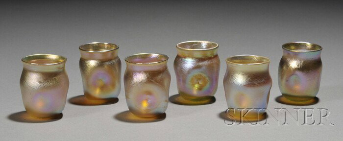 Six Tiffany Gold Favrile Shot Glasses Iridescent g: Six Tiffany Gold Favrile Shot Glasses Iridescent glass New York, early 20th century Each with four dimples on the side, inscribed L.C.T. on base, ht. 2 in.
