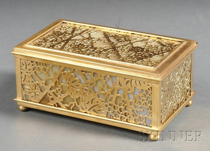 Tiffany Studios Grapevine Pattern Box Etched gilt : Tiffany Studios Grapevine Pattern Box Etched gilt bronze and glass New York, early 20th century Rectangular box with hinged lid with pierced bronze Grapevine pattern overlay over caramel slag glass, s