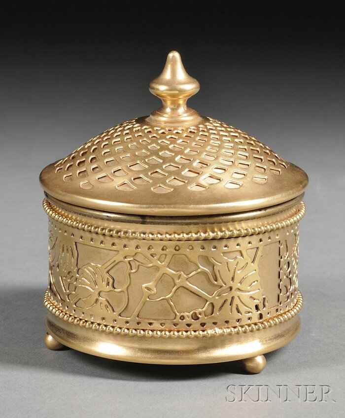 Tiffany Studios Grapevine Pattern Powder Jar Brigh: Tiffany Studios Grapevine Pattern Powder Jar Bright finish etched gilt bronze New York, early 20th century Cylindrical jar with lift-off cover with pierced bronze Grapevine pattern overlay over gilt-m
