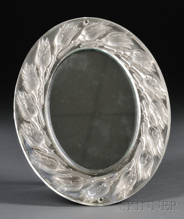 Lalique Dressing Table Mirror Molded and etched gl: Lalique Dressing Table Mirror Molded and etched glass, silver metal France, late 20th century Oval mirror frame ornamented around the rim with rosebuds, with beveled mirror, mounted to a sliver metal 