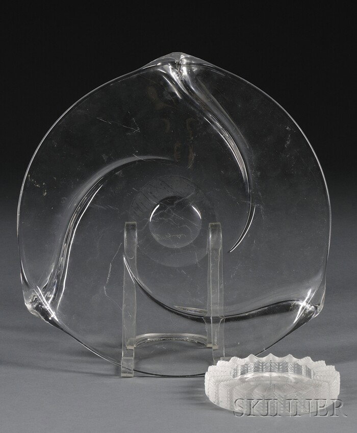 Lalique Ashtray and Val St. Lambert Center Plate M: Lalique Ashtray and Val St. Lambert Center Plate Molded etched and colorless glass France, 20th century Short cylindrical form with ridged rim and sides ornamented with leafy branches in relief, inscr
