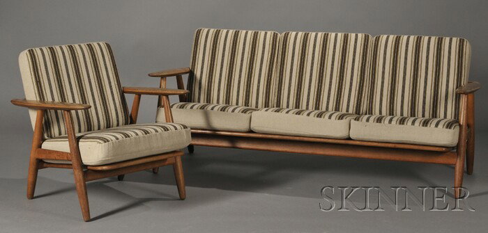 Hans Wegner Sofa and Armchair Red oak and upholste: Hans Wegner Sofa and Armchair Red oak and upholstery Sofa GE140, Chair GE240, design date c. 1955 Three back and three seat cushions on sofa supported on a stained red oak frame, respective ht. 28 3/4