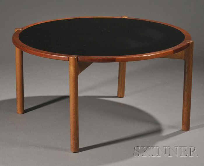Hans Wegner Coffee Table Teak, laminate, and oak D: Hans Wegner Coffee Table Teak, laminate, and oak Denmark, c. 1960 Reversible circular top one side wood the other with circular black inset, the frame with cut-outs to fit on four cylindrical legs, cr